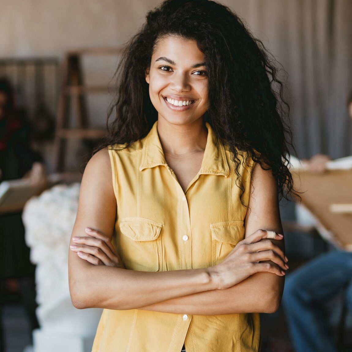 Young student woman smiling at camera during class in art school